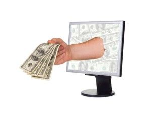 Hand with money and computer monitor, isolated on white background